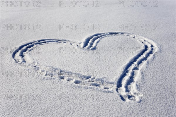 Heart in the snow on frozen lake