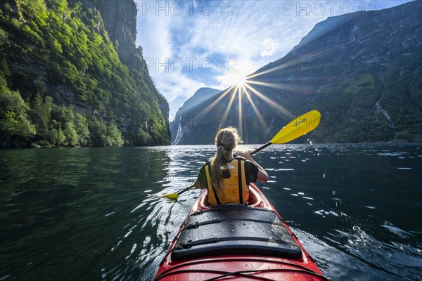 Young woman paddling in a kayak