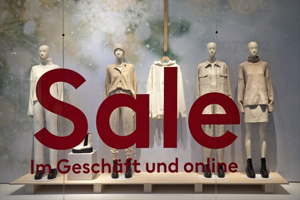 Shop window of a clothing store with the inscription Sale