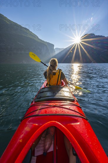 Young woman paddling in a kayak