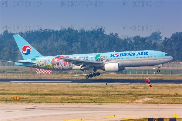 A Korean Air Boeing 777-200ER aircraft with registration number HL7766 in a special livery at Beijing Airport