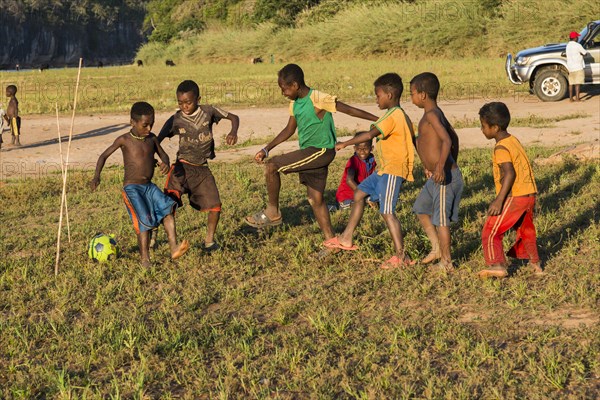 Children playing football at the ferry station across the Manambolo
