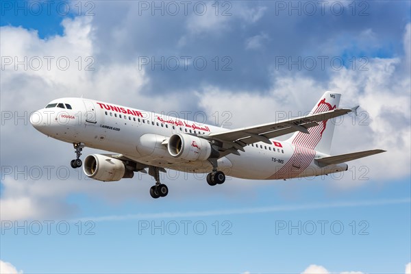 A Tunisair Airbus A320 with the registration TS-IMS lands at London Heathrow Airport