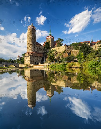 Old water art and St. Michael's church reflected in the water of the Spree