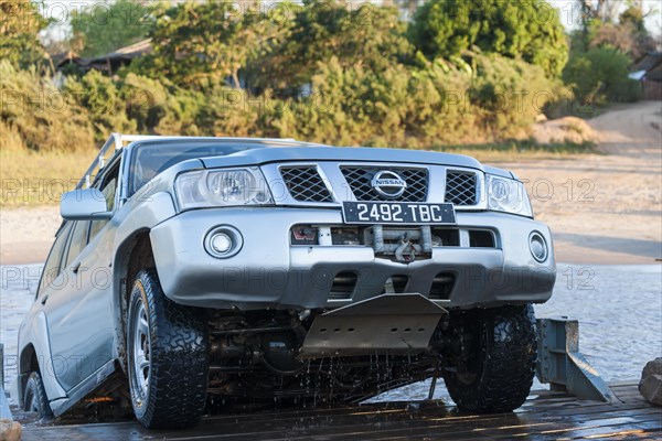 Off-road vehicle rides on ferry across the Manambolo