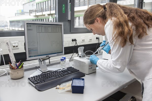 Scientist of biology pipetting in the genetic engineering area of the laboratories of the University of Duisburg-Essen