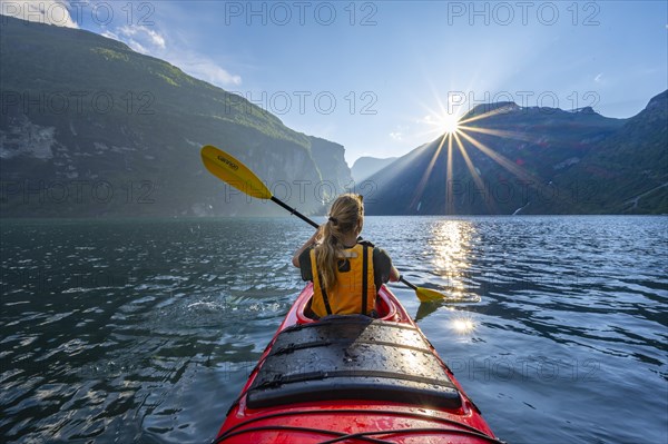 Young woman paddling in a kayak