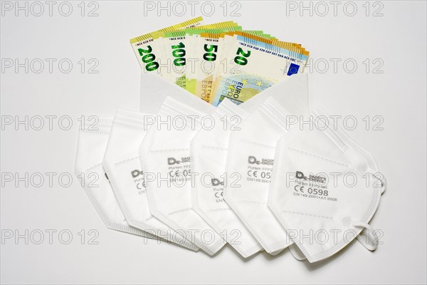 6 FFP 2 masks in front of envelope with EUR banknotes
