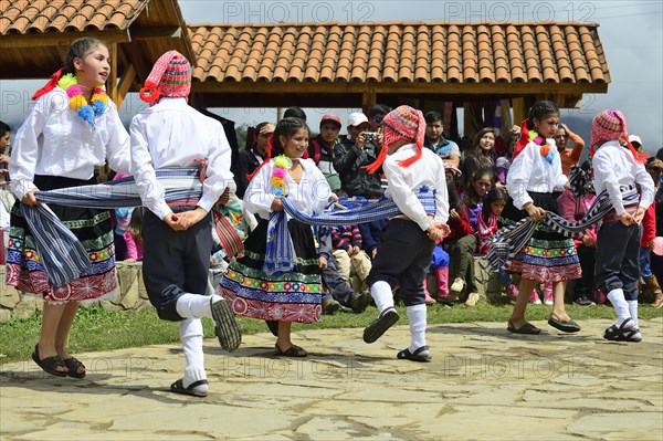 Young dance group in colorful costumes at a folk festival