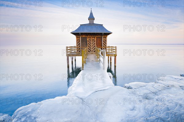 Iced bathhouse at dusk