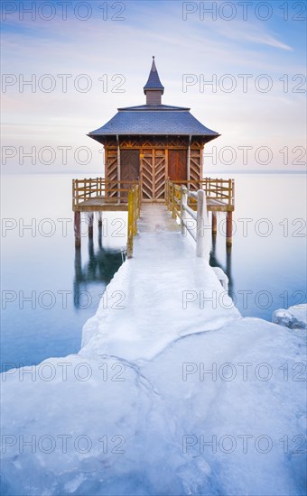 Iced bathhouse at dusk