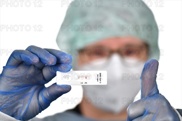 Medical staff shows negative antigen rapid test