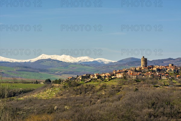 Village of Montpeyroux and view on Sancy massif in winter