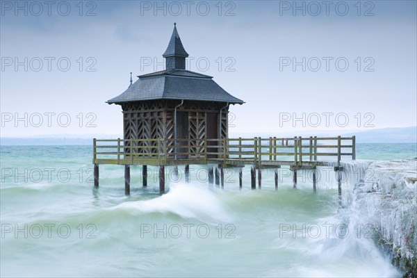 Iced bathhouse in stormy wind