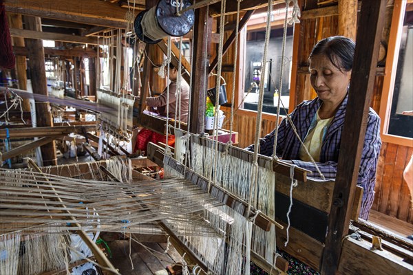 Burmese woman weaving lotus silk