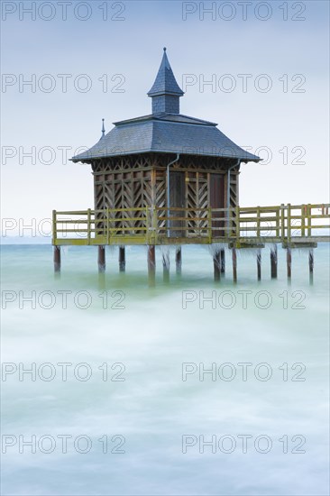 Iced bathhouse in stormy wind