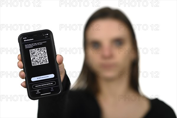 Woman holding Luca app with QR code