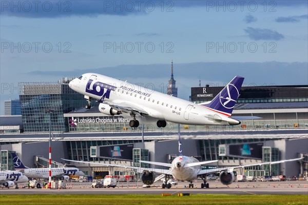 An Embraer 175 of LOT Polskie Linie Lotnicze with the registration SP-LIC takes off from Warsaw Airport