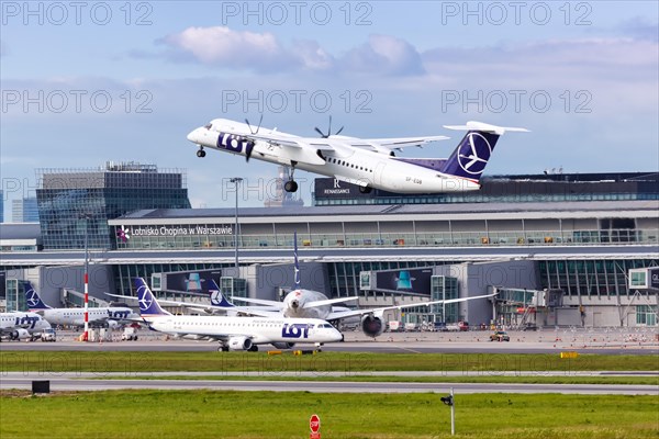 A Bombardier DHC-8-400 of LOT Polskie Linie Lotnicze with the registration SP-EQB takes off from Warsaw Airport