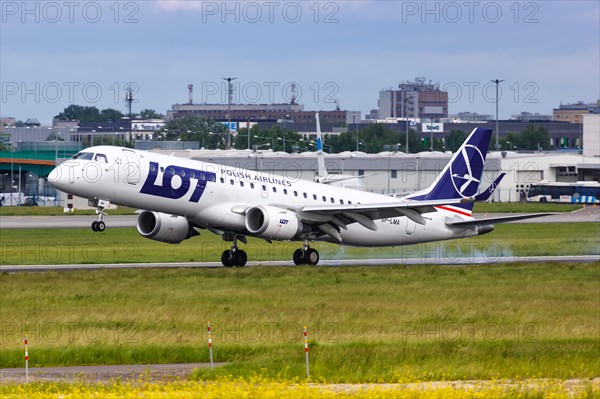 An Embraer 190 of LOT Polskie Linie Lotnicze with the registration SP-LMA lands at Warsaw Airport