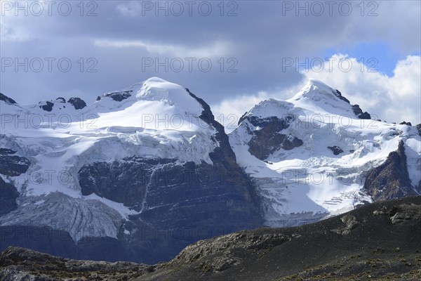 Iced mountain peaks with clouds