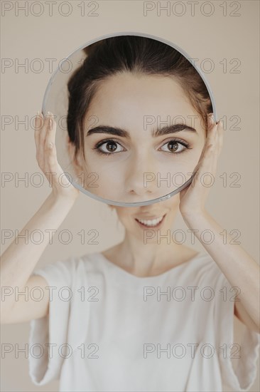 Young woman with mirror