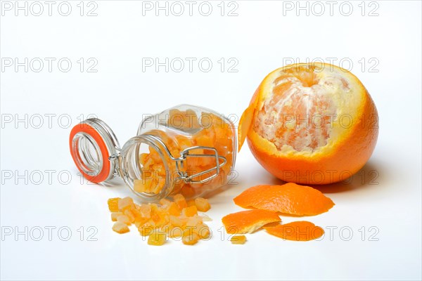 Candied orange peel cubes in glass