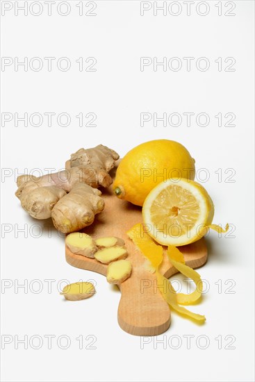 Ginger root and lemon on wooden board