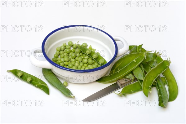 Green peas in pod and knife