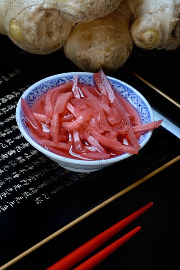 Pickled ginger in small bowls and ginger root