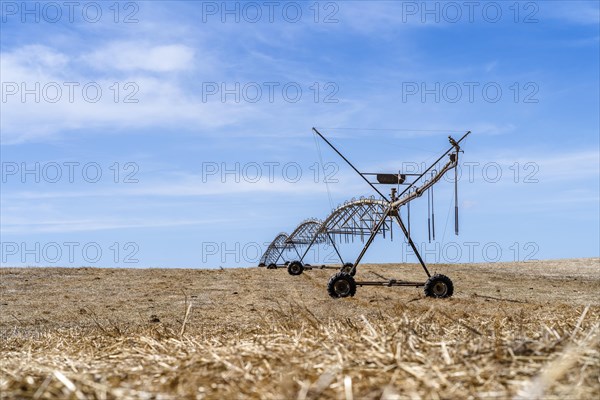 Moving irrigation system standing on a dry stubble field in Alentejo