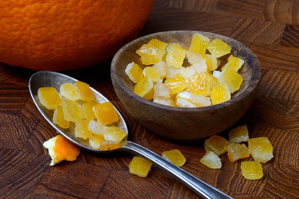 Candied orange peel cubes in small bowls and spoon
