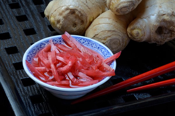 Pickled ginger in small bowls and ginger root