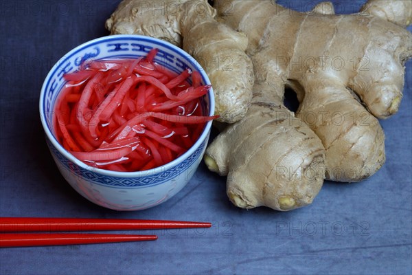 Pickled ginger in small bowls and ginger root