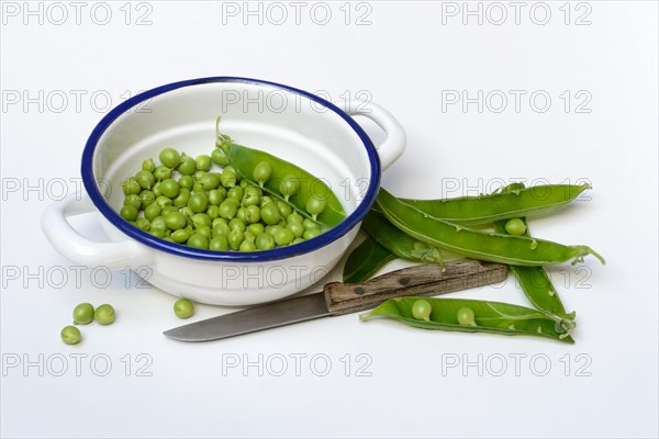 Green peas in pod and knife