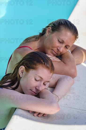 Woman with daughter at pool