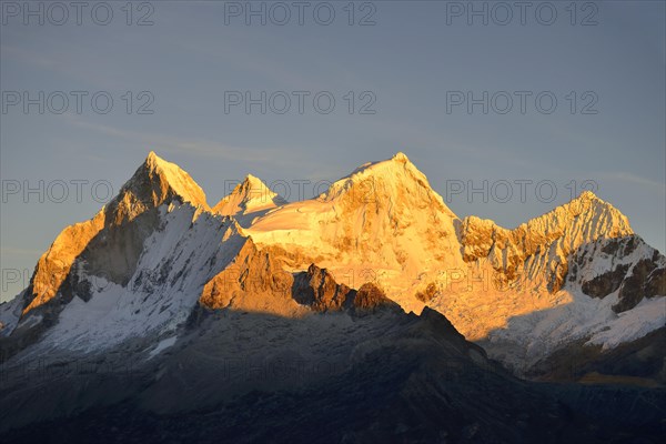 Shining mountain range Nevado Huandoy at sunrise