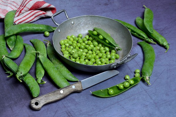 Green peas in pod and knife