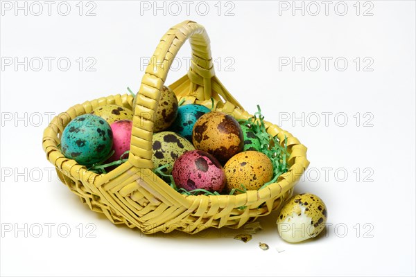 Coloured quail eggs in baskets