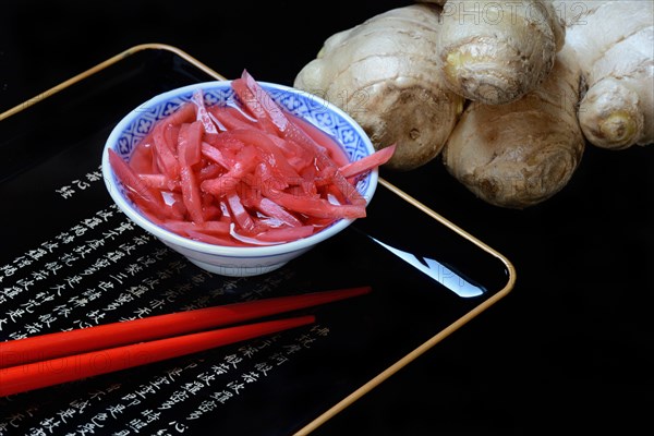 Pickled ginger in small bowls and ginger root