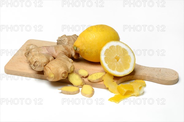 Ginger root and lemon on wooden board