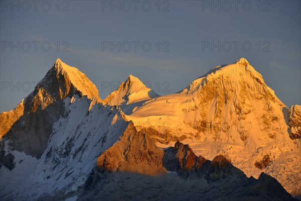 Shining mountain range Nevado Huandoy at sunrise