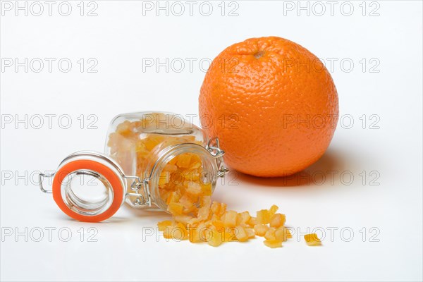 Candied orange peel cubes in glass