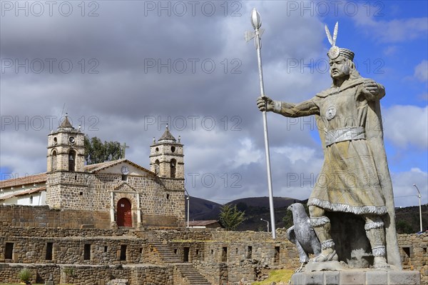 Statue of the Inca Pachacutec in front of sun temple with attached cathedral from the colonial period