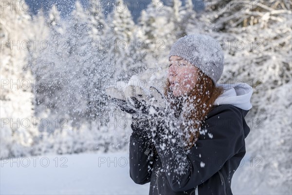 Woman enjoying the snow during winter walk