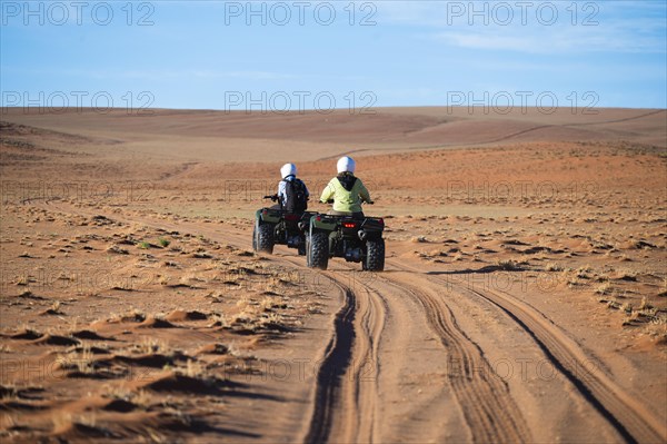 Quadbiker on sand track in the Namib