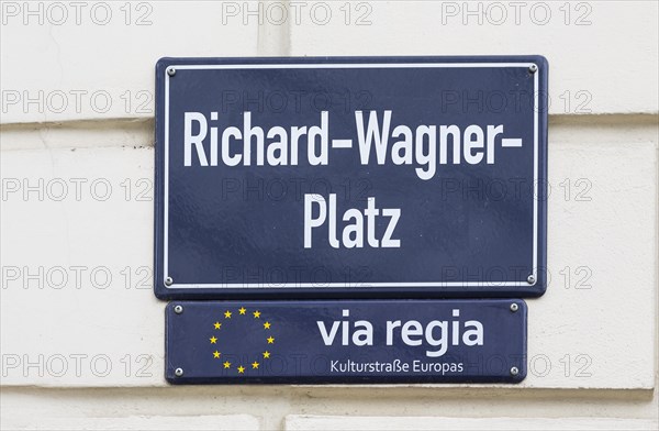 Street sign Richard-Wagner-Platz and sign for the Via Regia European Cultural Route on a house wall