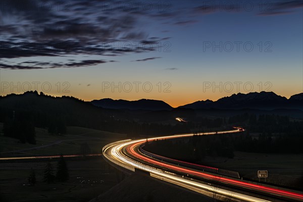 Motorway at blue hour with traces of cars in Allgaeu landscape