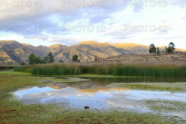 Reflection of bare hills in the Laguna Pumaqucha at the Inca ruins of Inti Watana