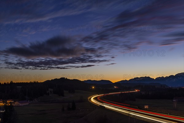 Motorway at blue hour with traces of cars in Allgaeu landscape